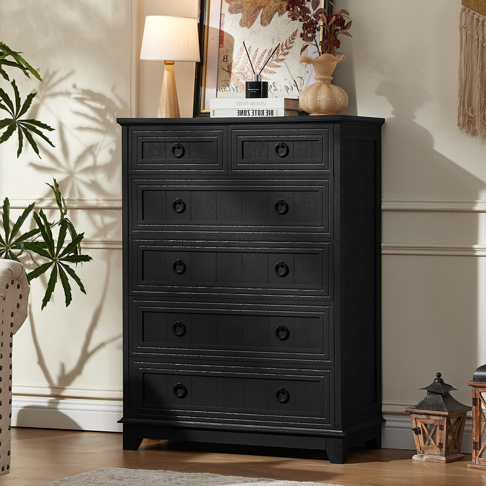 Dark painted wood dresser with five drawers and round metal knobs, farmhouse style.