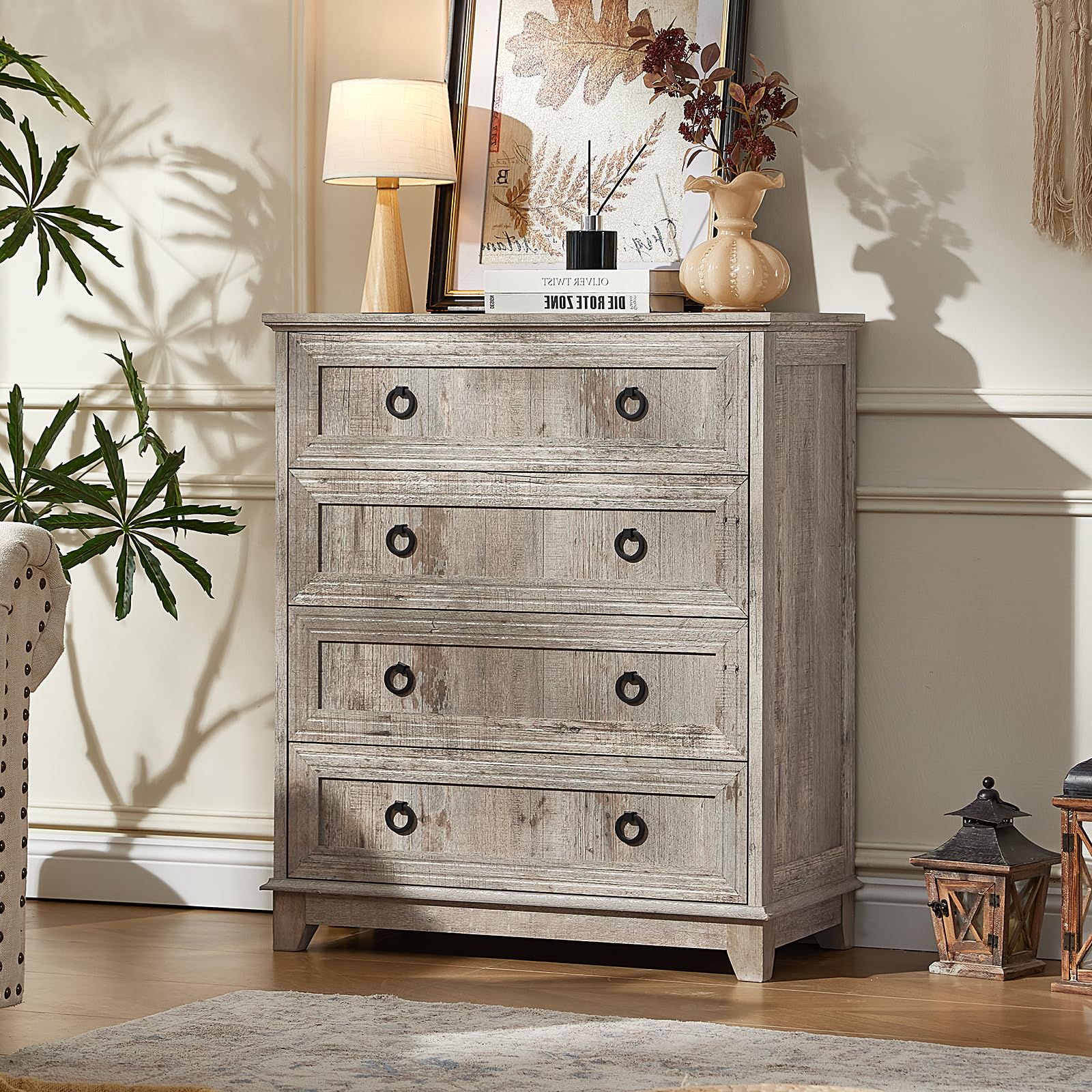 Grey farmhouse dresser with multiple drawers and round metal knobs on the cabinet fronts.