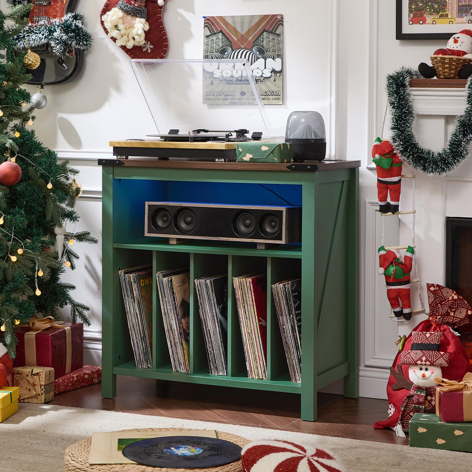 Green record player cabinet with open shelf for vinyl records and front storage.