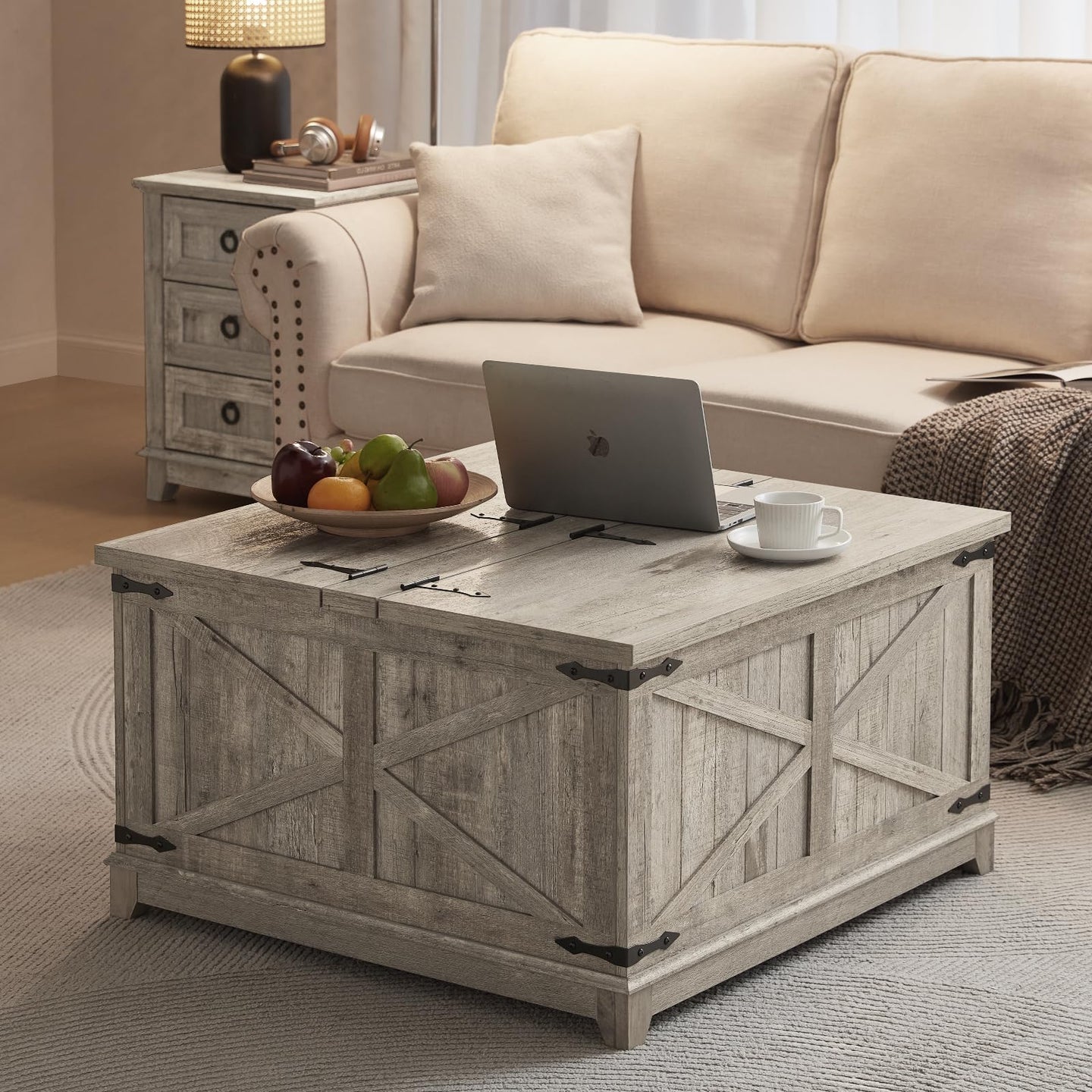 Gray-washed farmhouse coffee table with flip-top lid, black hinges, and hidden storage.