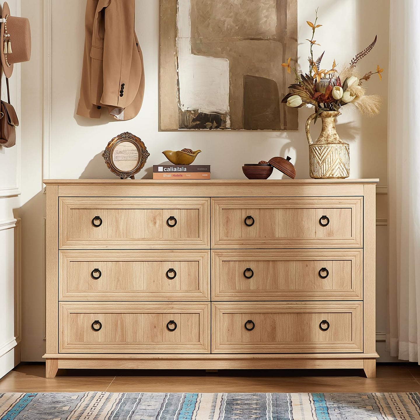 Light wood 6-drawer dresser with black round knobs and paneled drawer fronts