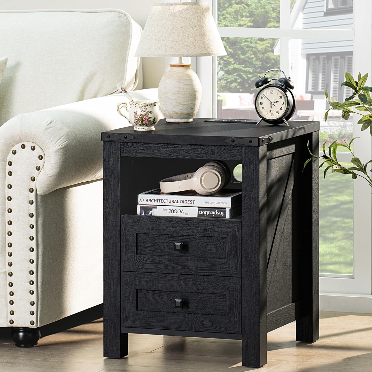 Dark nightstand with 2 drawers and open shelf, tablet and decor on top