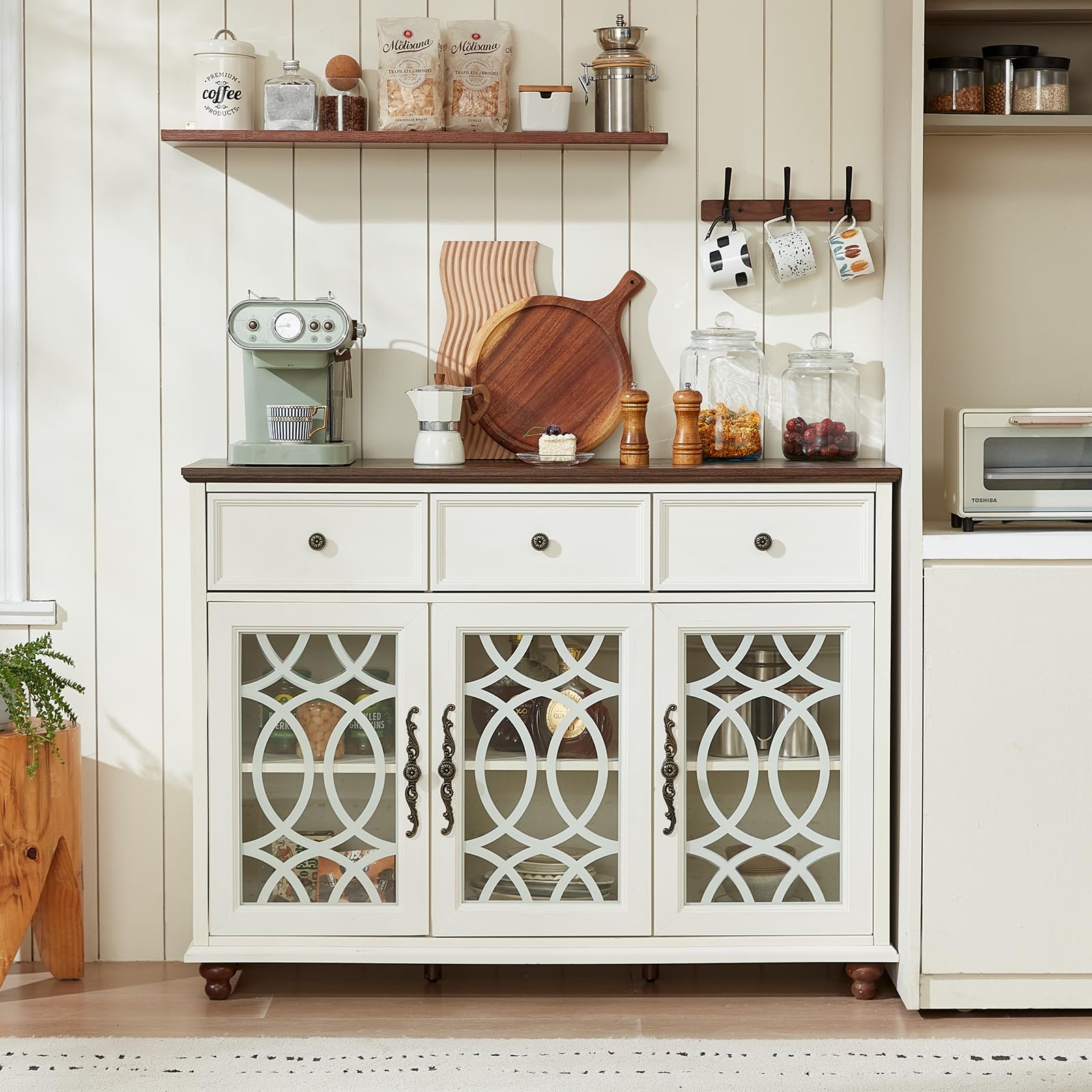 White sideboard buffet with three drawers and three glass-panel door cabinets