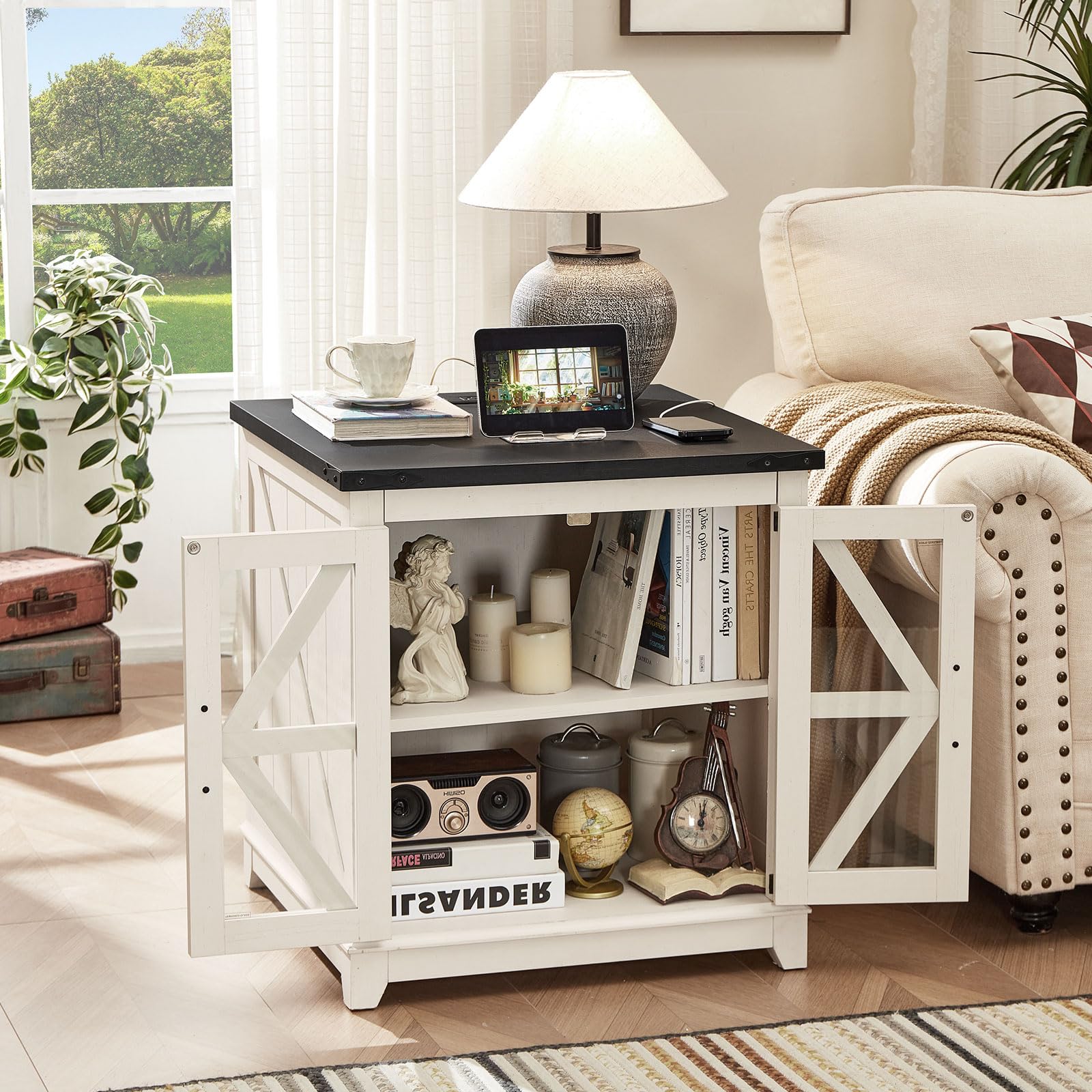 White wood end table with black top and open shelves behind glass barn doors