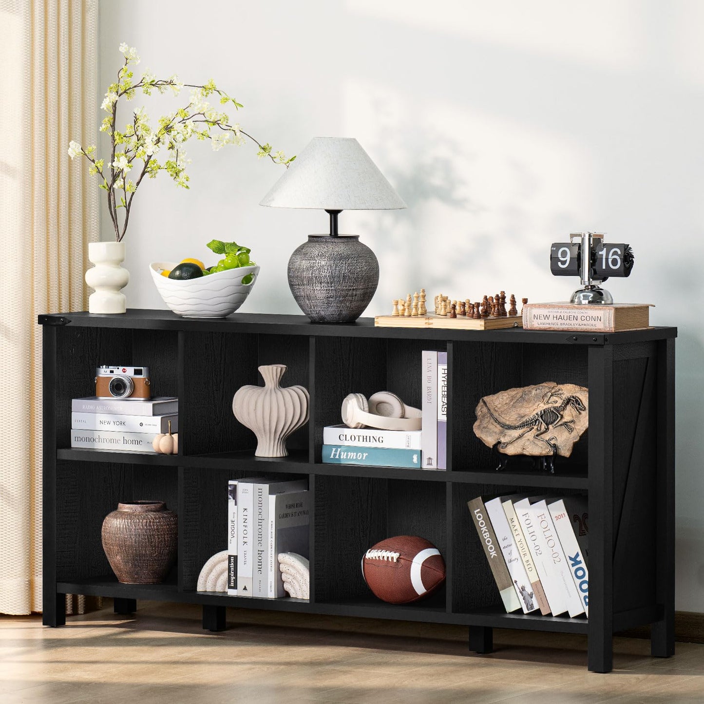 Black wood bookcase with open shelves and multiple storage cubbies