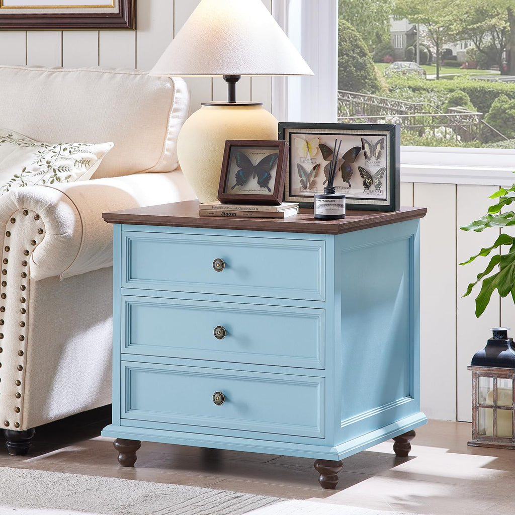 Light blue dresser with three drawers and round knobs on turned wooden feet