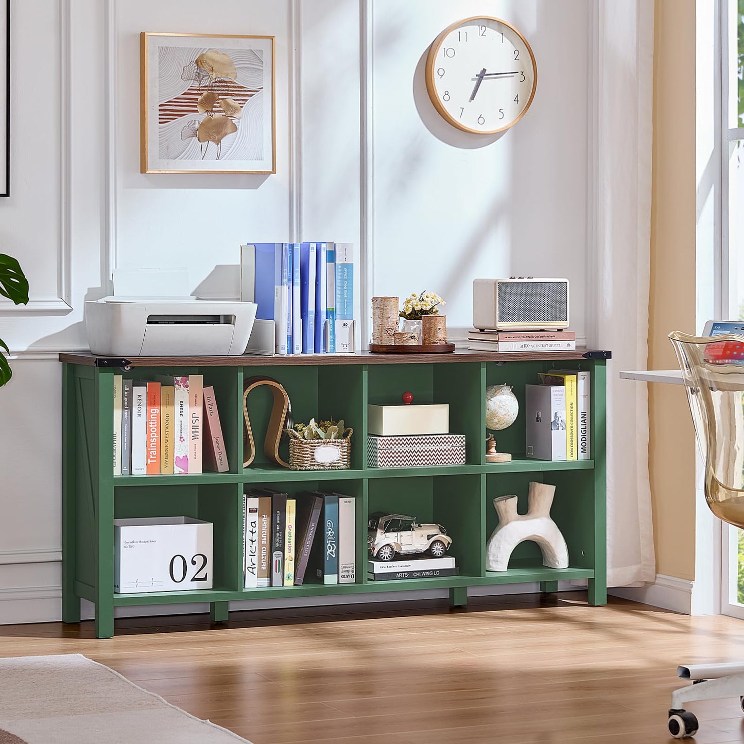 Green storage bookcase with open cubby shelves filled with books and small decor