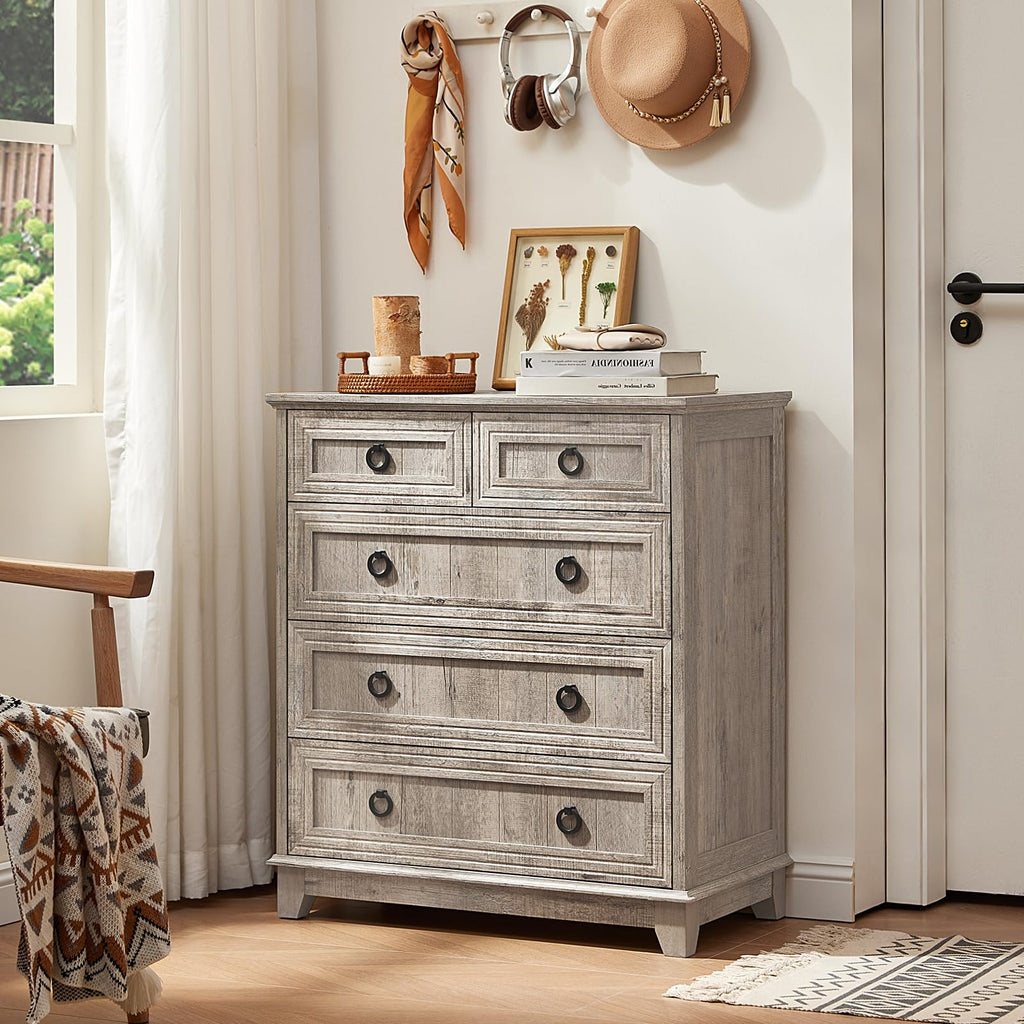 Gray farmhouse dresser with four visible drawers, round metal knobs, distressed finish