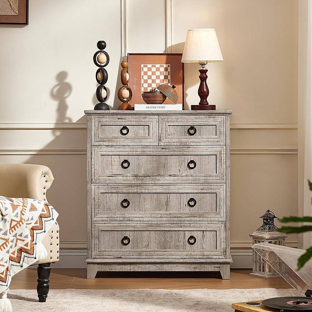 Gray farmhouse dresser with five drawers and round metal knobs, distressed wood finish