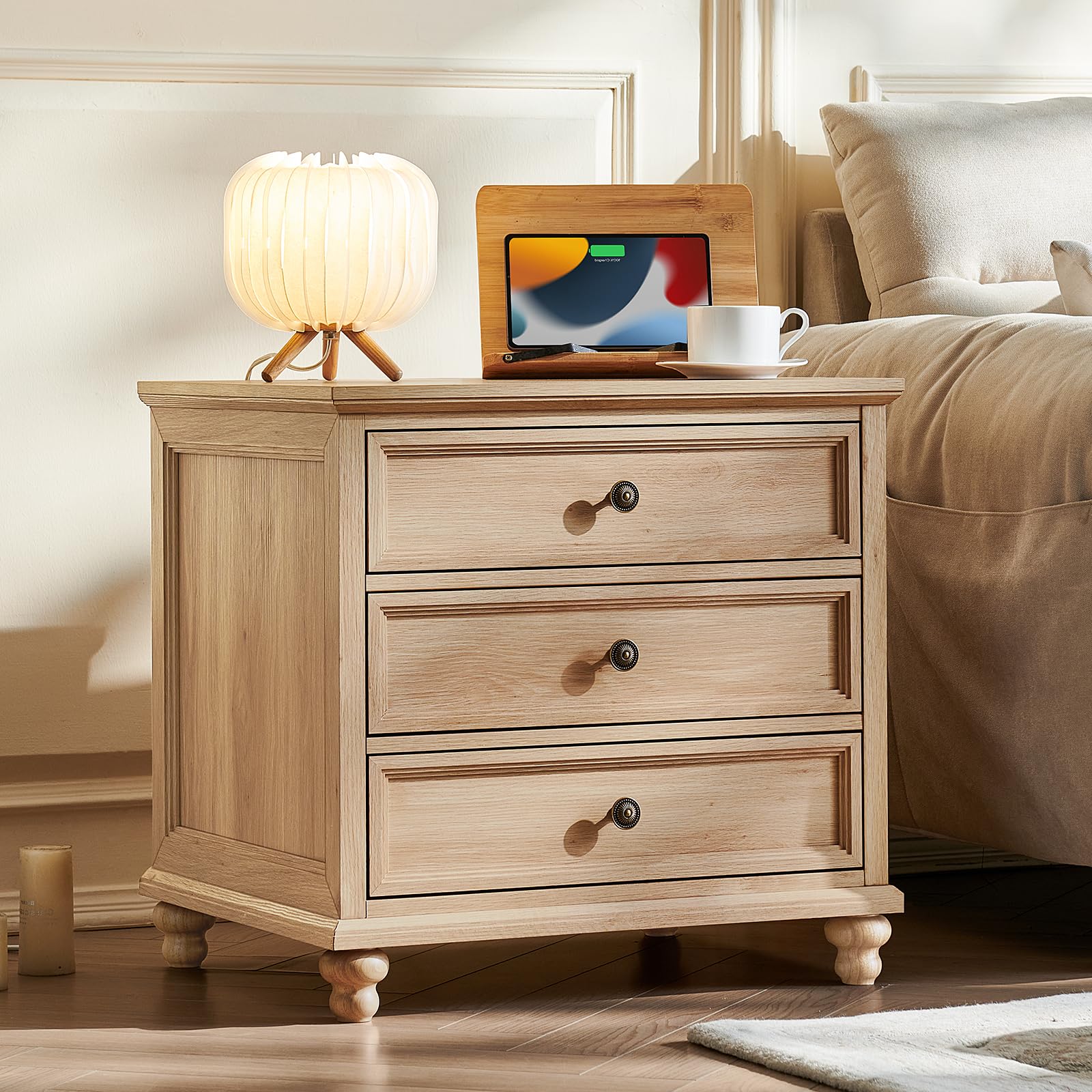 Light wood farmhouse nightstand with three drawers and round metal knob pulls