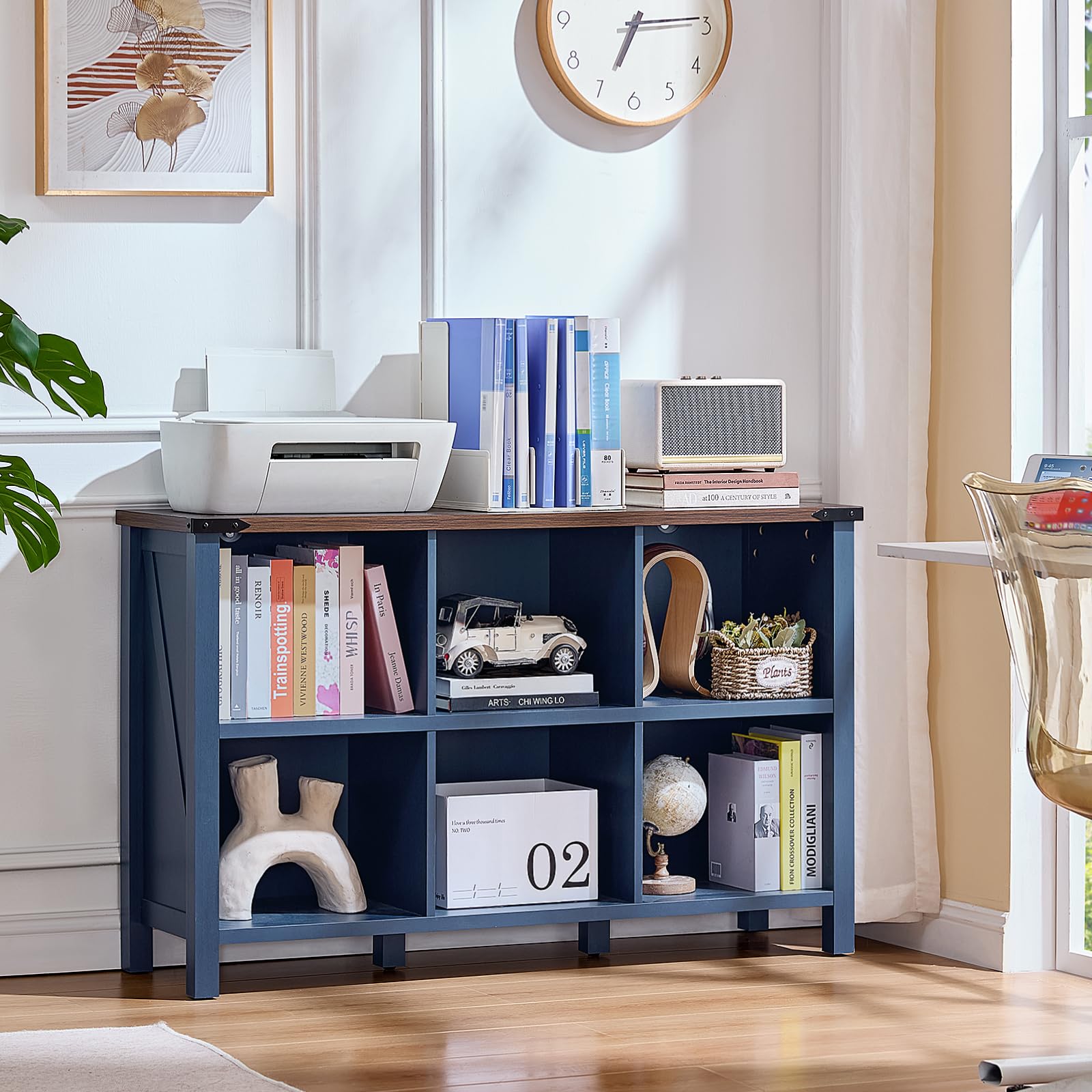 Navy blue low bookcase with open cubby shelves for books and decor