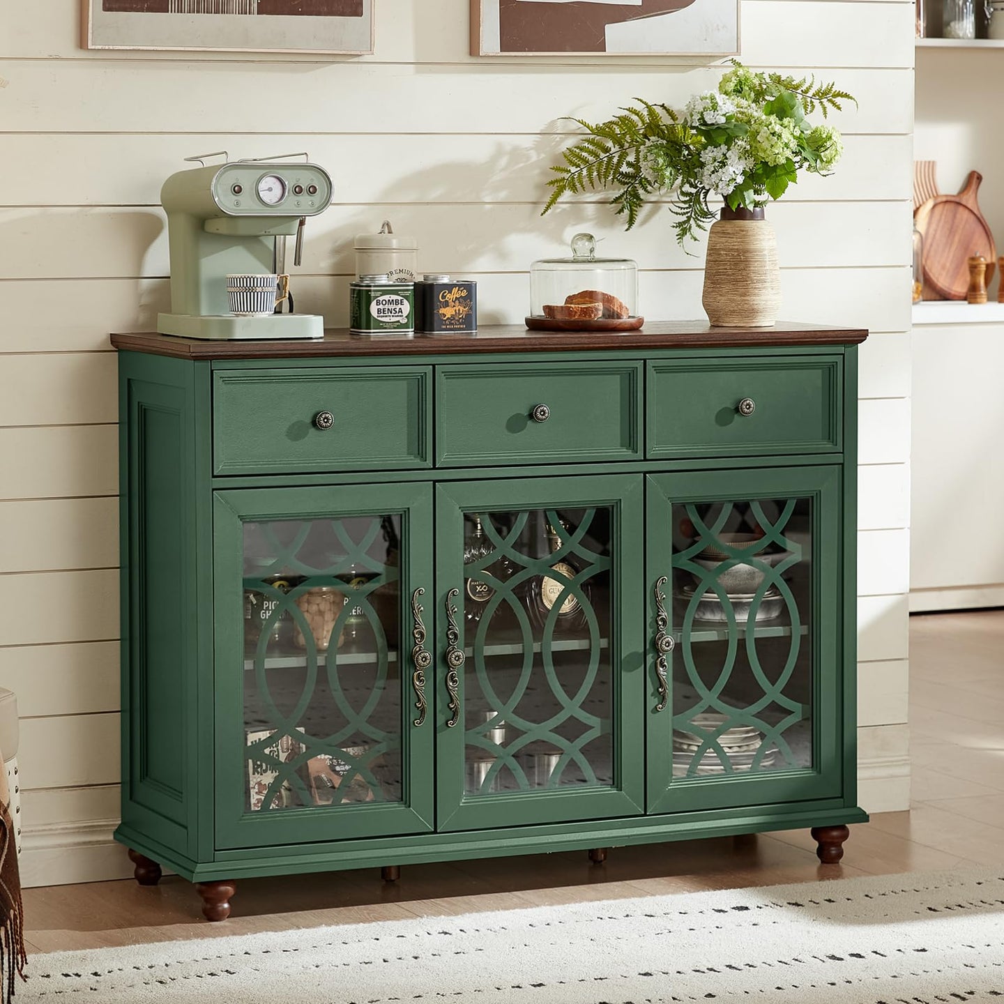 Green farmhouse sideboard cabinet with three arched glass doors, top drawers, and wooden legs
