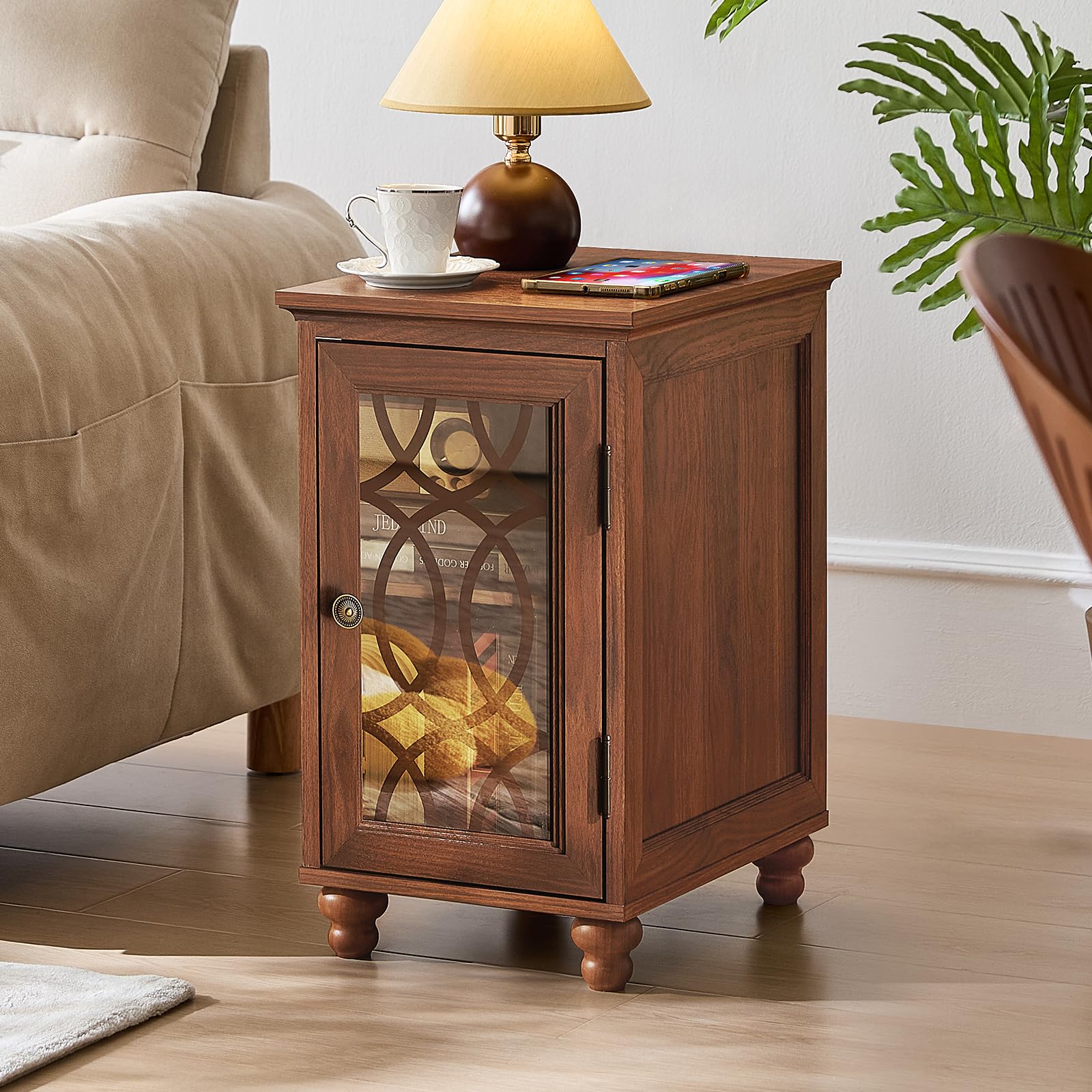Wooden bedside end table with glass door, decorative metal panel, and turned legs.