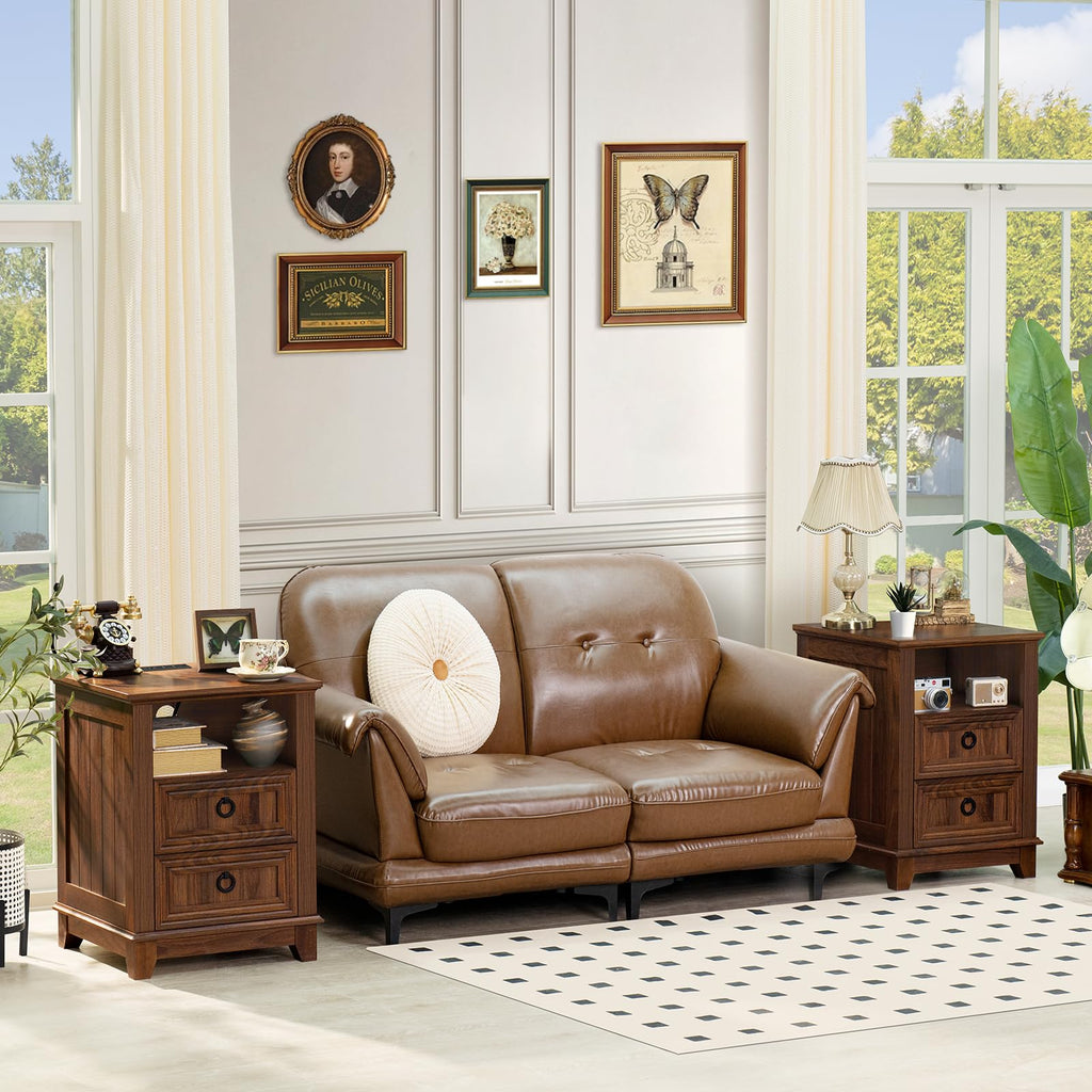 Wood nightstand cabinet with two drawers and metal ring pulls, next to sofa