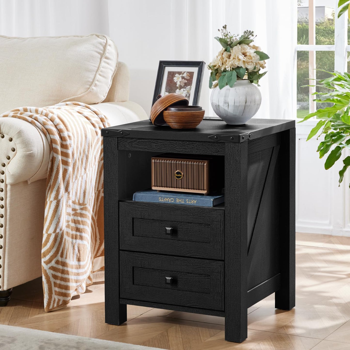 Black wooden nightstand with 2 drawers and open shelf, metal handle pulls and corner hardware.