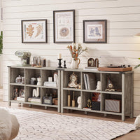 Light grey console bookcase with open cubbies and shelves, styled with books and vases