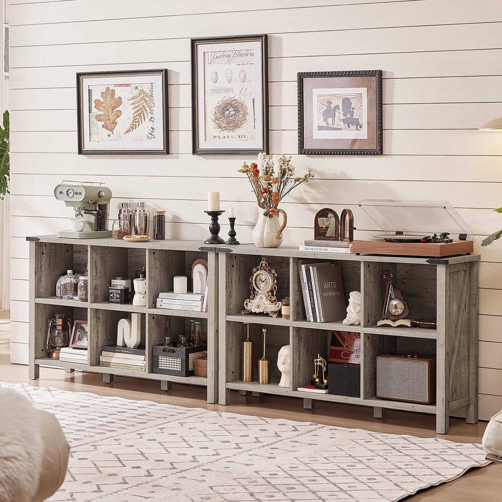 Light grey console bookcase with open cubbies and shelves, styled with books and vases