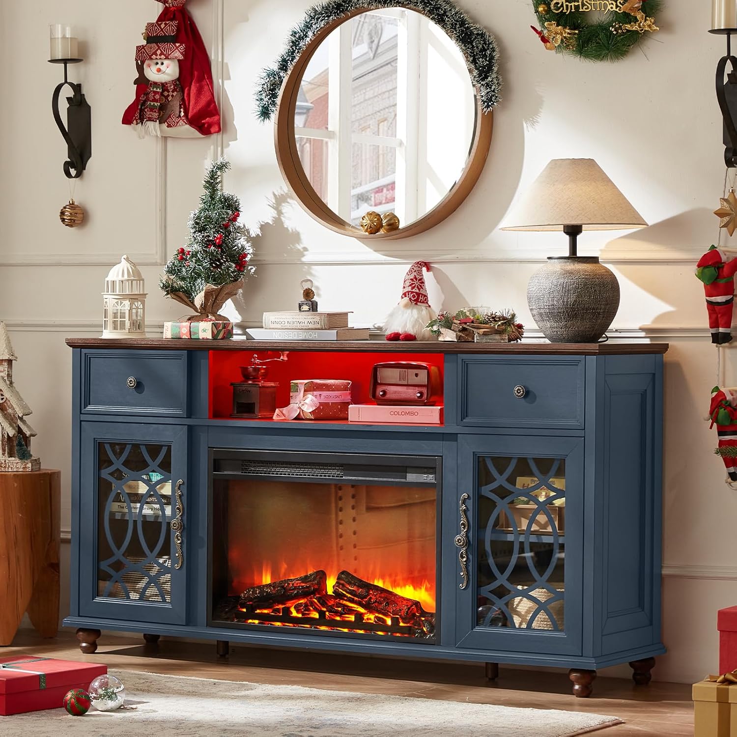 Blue farmhouse fireplace TV stand with lit electric fire and glass cabinet doors