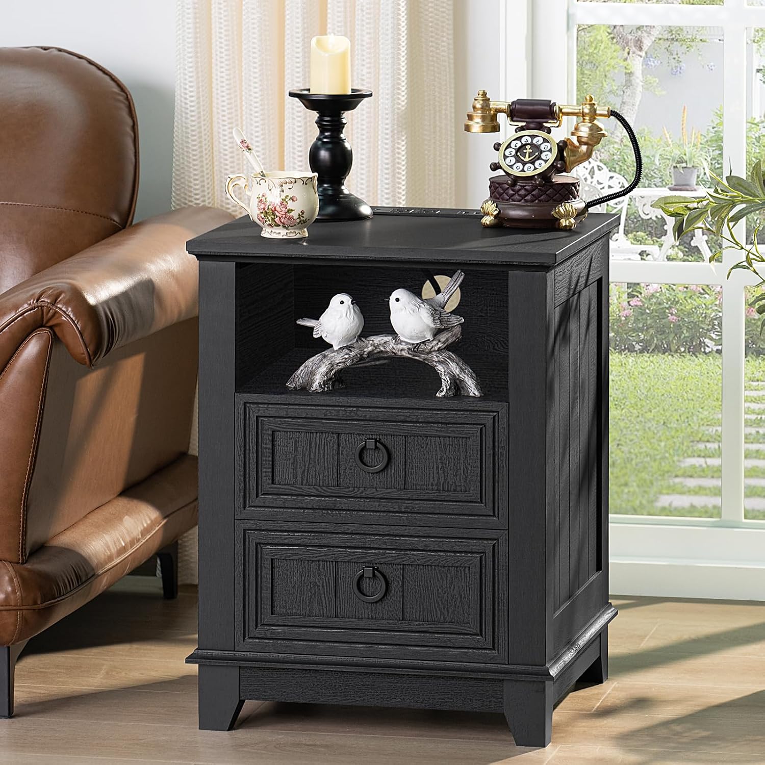 Black wooden nightstand with two drawers and front bunny motif panel