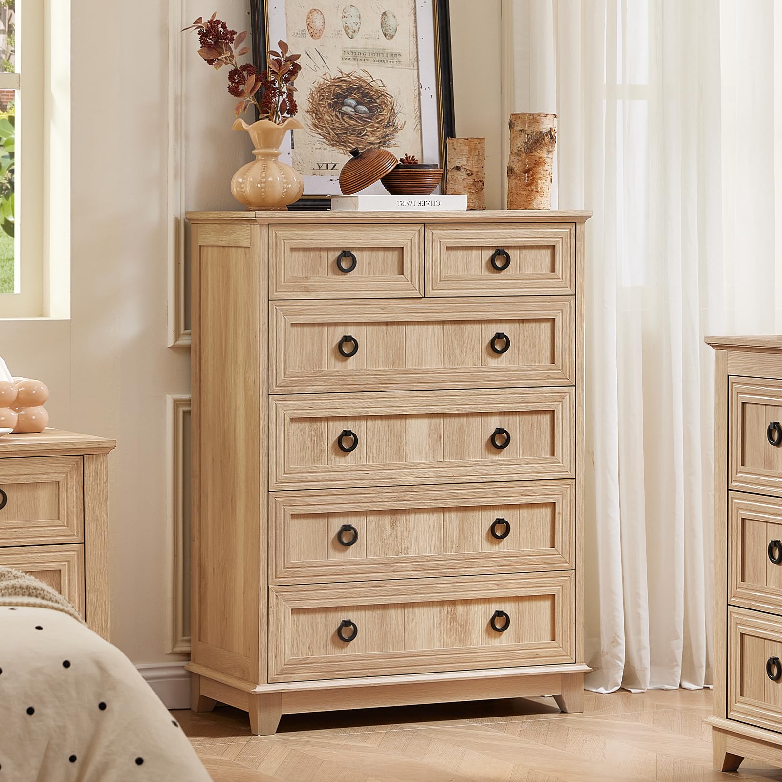 Light natural wood dresser with five drawers and round bronze handles