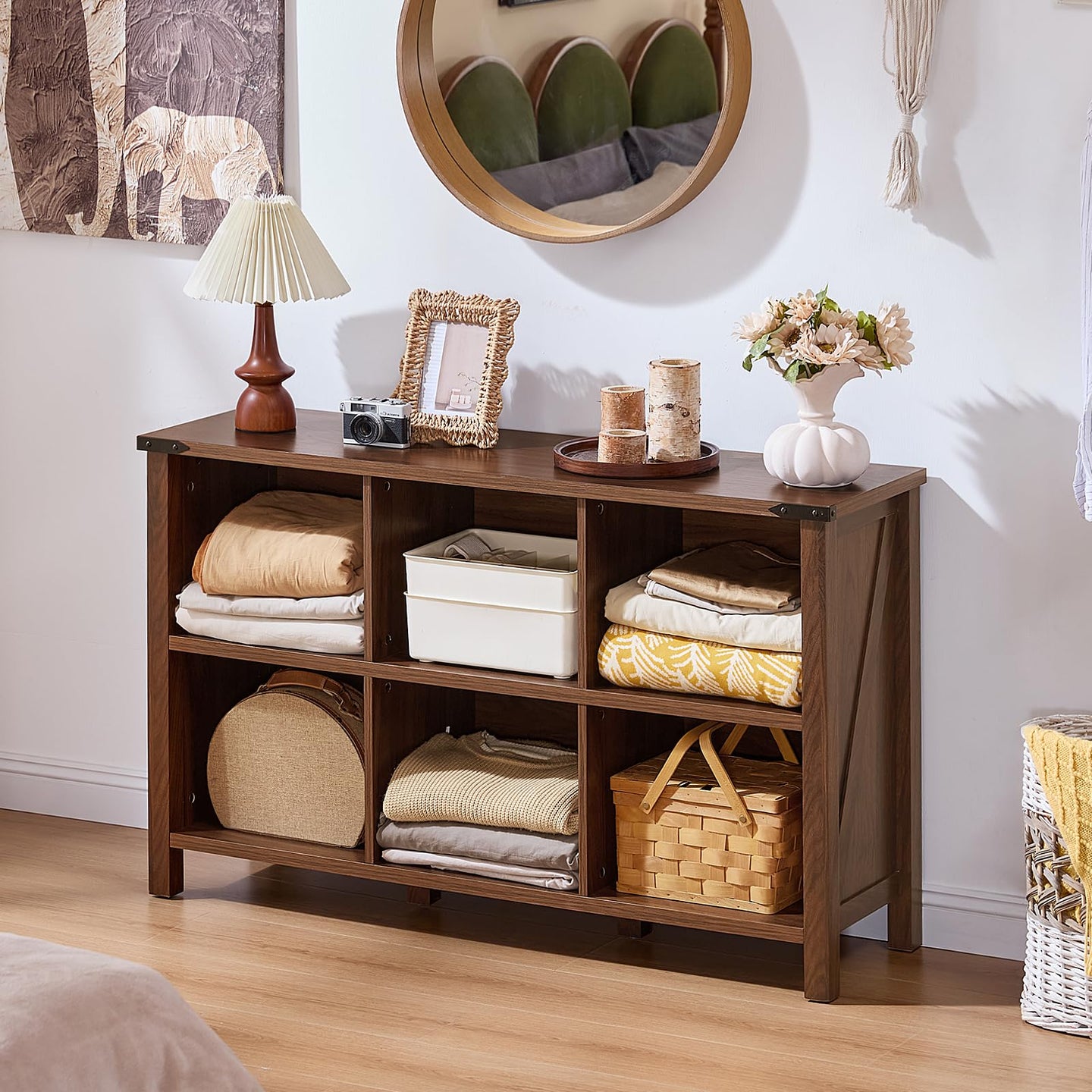 Brown farmhouse bookcase with open shelves, central storage drawer, and legs