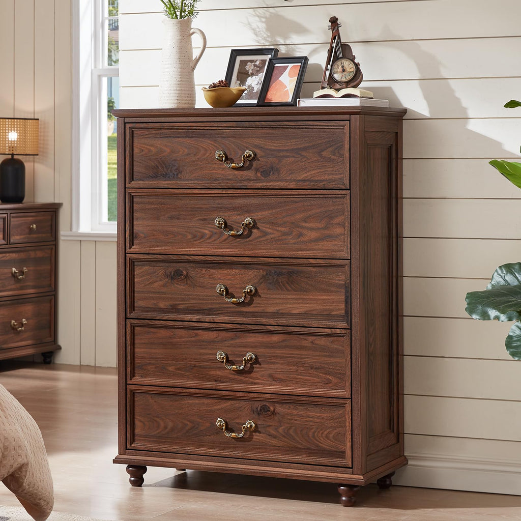 Brown wood dresser with four drawers and bronze knobs, on turned feet