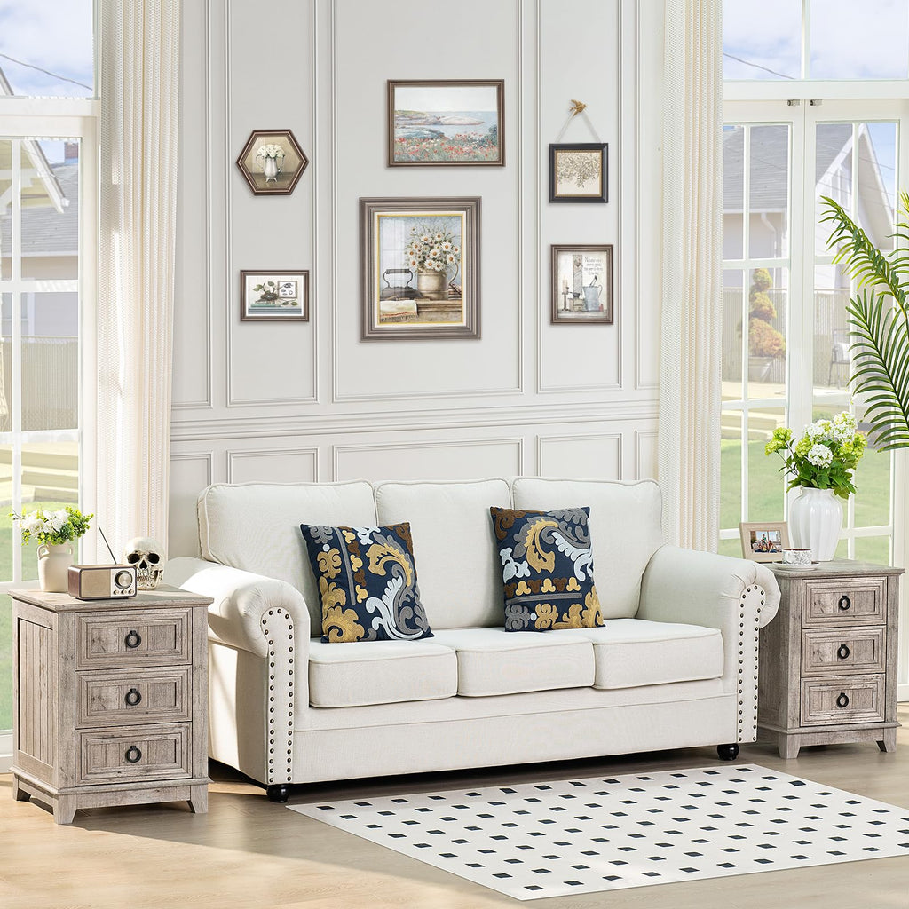 White farmhouse nightstand with three drawers and round metal handles