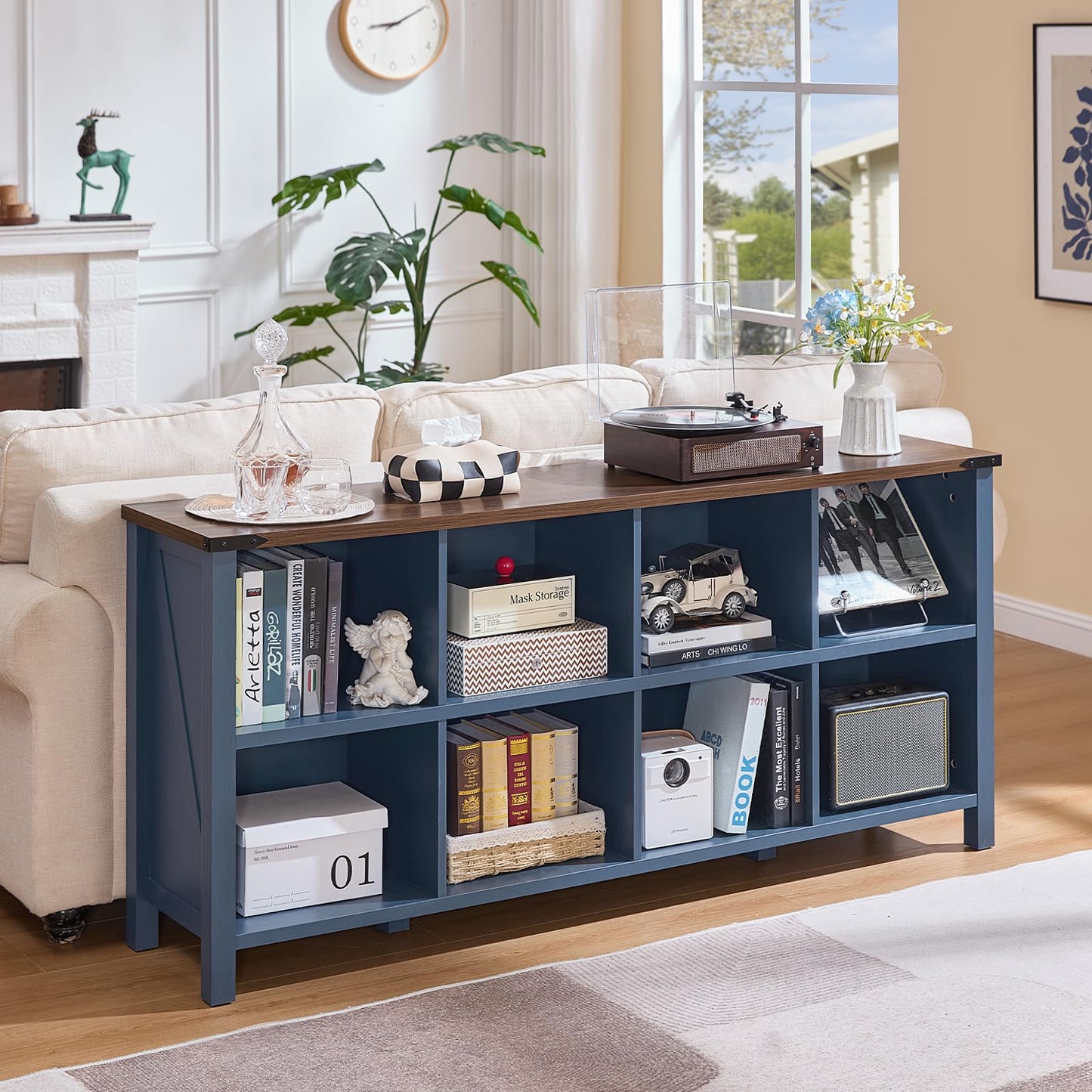 Blue console bookcase with open storage shelves and side compartments on legs