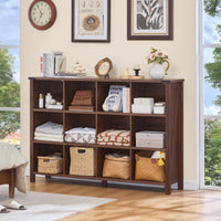 Brown bookcase with open cubbies and baskets, styled with folded textiles and decor