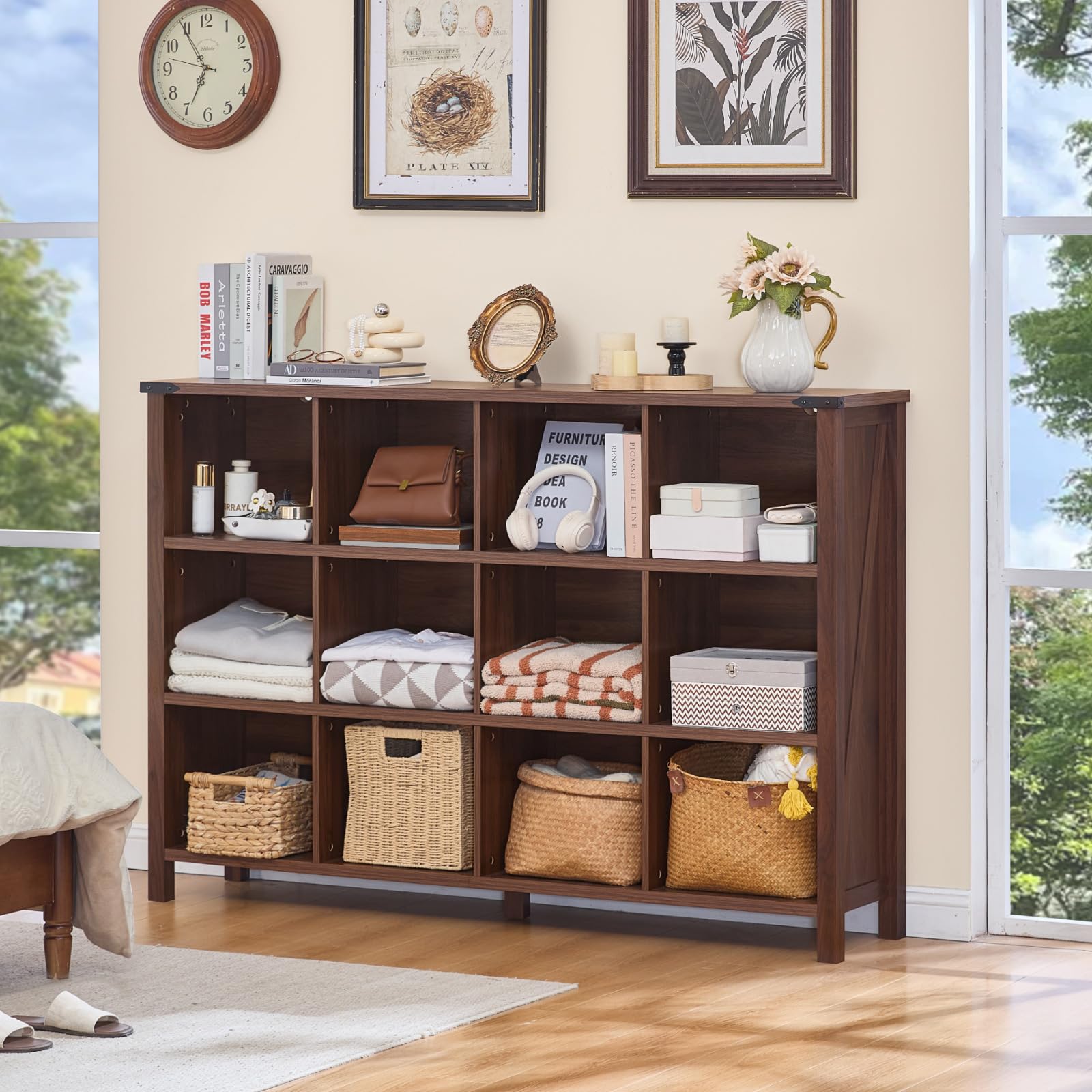 Brown bookcase with open cubbies and baskets, styled with folded textiles and decor