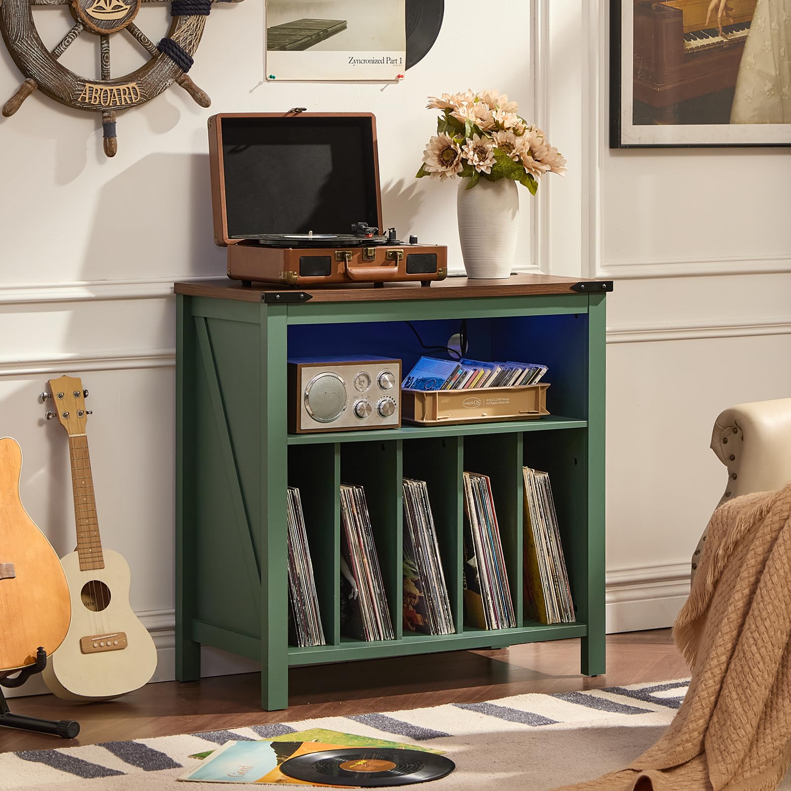 Green record player storage cabinet with vinyl record shelves and a turntable on top.