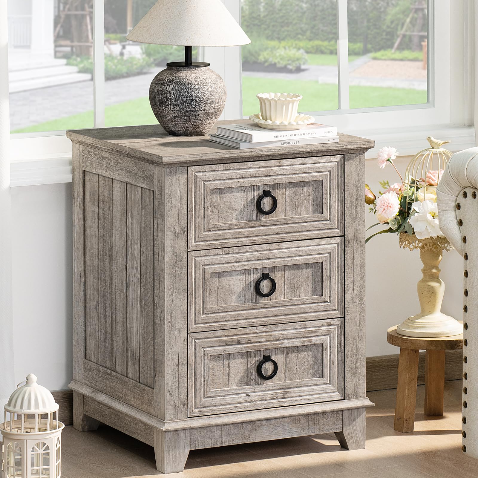 Gray nightstand cabinet with three drawers and round metal handles